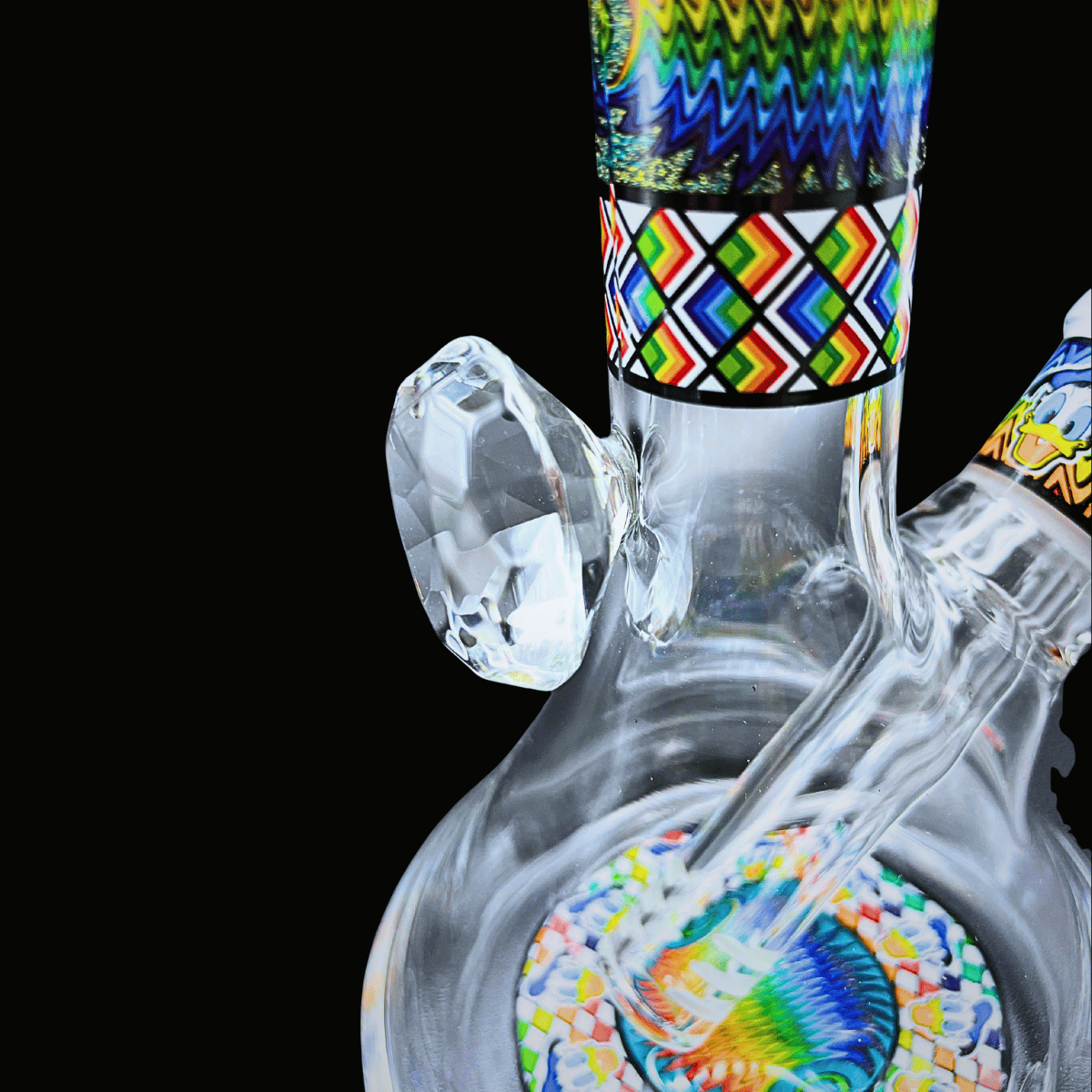 Side view of Donald Duck glass bong showing patterned neck and glass bowl