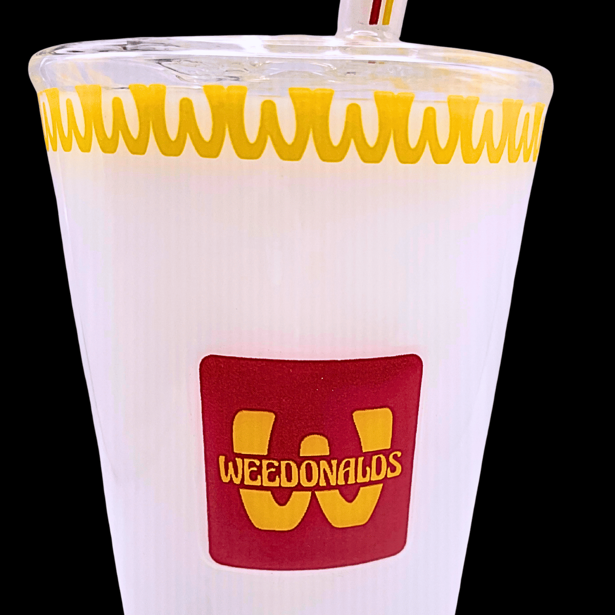 Close-up of HEMPER Weedonald’s Soda Cup bong with yellow rim and cup artwork