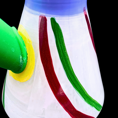 Close-up of the Rasta Rascal bong’s striped glass base and green bowl connection
