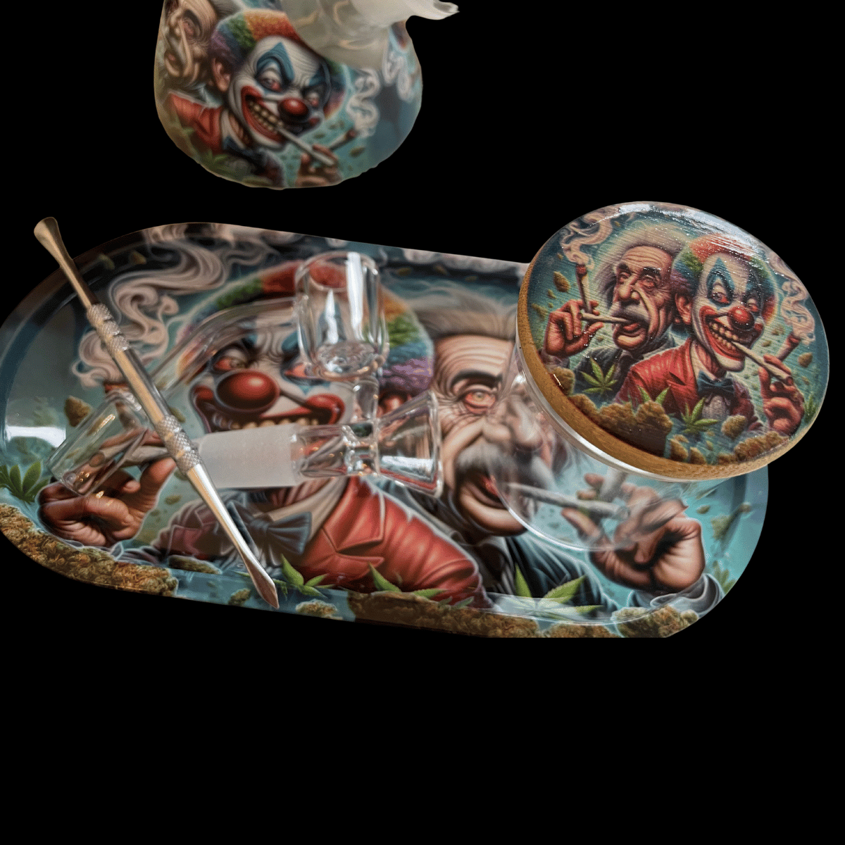 A smoking accessory set featuring a large oval tray and a matching round coaster, both decorated with detailed, colorful clown illustrations. A clear glass water pipe with a metal stem rests on the tray, and a small clear glass bowl is shown above the tray against a solid black background.