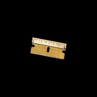 Gold single-edge razor blades — tidy trays; not for cocaine